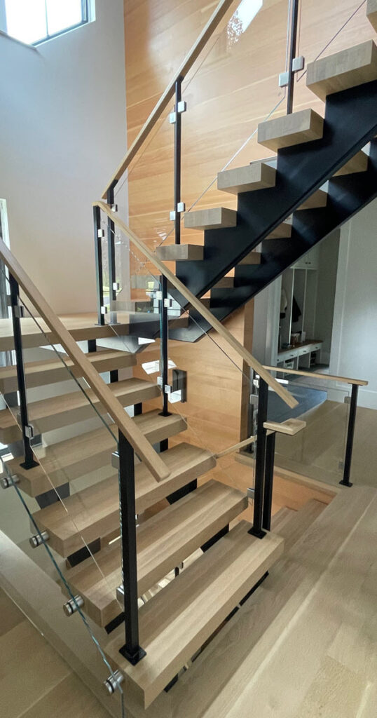 Double stringer stair styles - Hollow form duo stringer with wood treads and completely concealed hardware and glass railing.