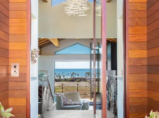 Flow through view of ocean vista from the open front door 