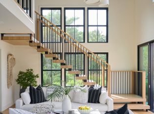 Spindle railing featured on double stringer floating staircase